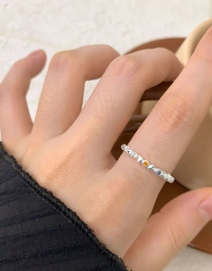 Close-up of S925 silver heart ring with colorful zircon stones on a female finger