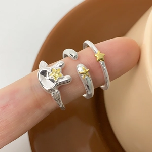 Three-piece S925 silver star ring set with gold accents worn on fingers