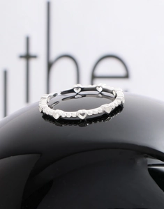 Close-up of S925 silver open ring with intricate hollow heart-shaped patterns