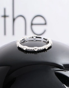 Macro shot of S925 sterling silver heart-shaped ring with delicate bead details
