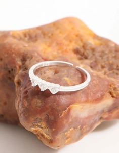 Detailed shot of S925 sterling silver ring with three heart-shaped cubic zirconia stones