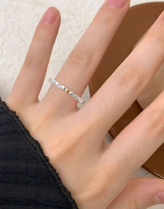 Detail of silver S925 heart ring with colorful zircon inlay worn on finger