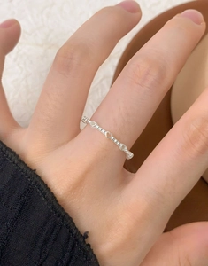 Detailed close-up of S925 sterling silver beaded ring with hollow heart designs on hand