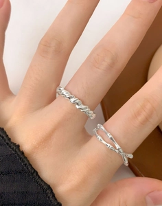 Close-up of stacked S925 sterling silver rings with irregular twisted rope and bamboo textures