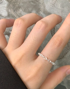 Close-up of minimalist S925 sterling silver chain ring worn on a finger