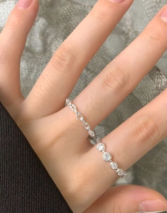 Close-up of S925 sterling silver chain ring and pave-set cubic zirconia ring worn together