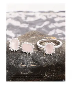 Macro shot of S925 sterling silver stamp on pink crystal jewelry set displayed on dark stone