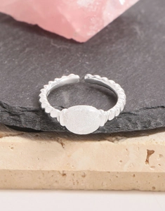 Macro detail of S925 sterling silver twisted ring with frosted oval finish and hallmark