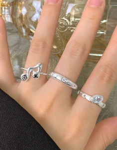 Detailed view of three-piece silver musical note and star engraved rings set
