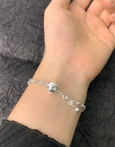 Detailed view of S925 sterling silver ball chain bracelet on wrist with adjustable clasp