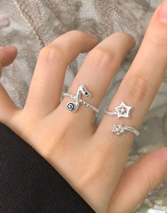 Detail of S925 sterling silver musical note bead ring and star open ring worn on finger