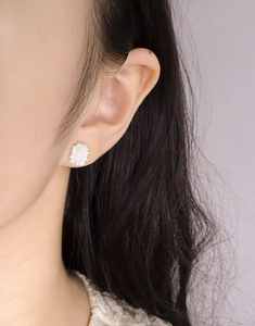 Close-up of elegant S925 silver stud earring featuring rectangle gemstone on model ear