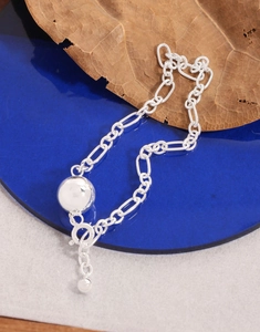 Detail of S925 sterling silver Figaro chain bracelet with polished ball and OT toggle clasp