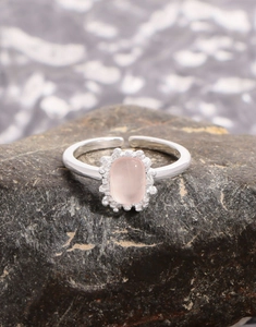 Detailed view of pink quartz S925 silver ring with oval stone on natural stone base