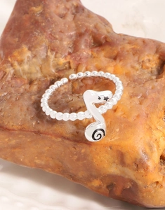 Close-up of S925 sterling silver music note ring with star engraving on natural stone