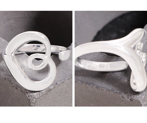 Macro shot of S925 sterling silver stamp on minimalist hollow heart-shaped ring