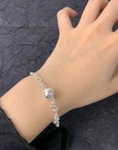 Detailed close-up of S925 sterling silver ball bracelet with polished metal sphere