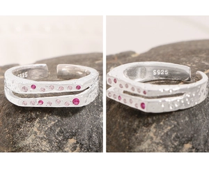 Macro detail of S925 sterling silver ring showing double-layer texture and pink zircons