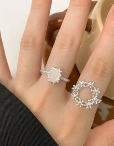 Macro detail of S925 silver rings with pink gemstone and micro-bead textured design
