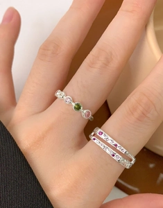 Macro shot of double-layer S925 silver rings with colorful zircon inlay on fingers