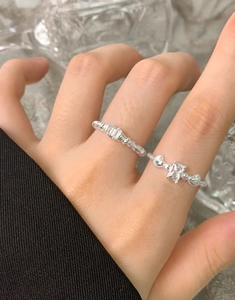Macro detail of S925 sterling silver rings with zircon stones and heart-shaped accents