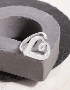 Macro detail of S925 sterling silver stamp and polished inner band on heart ring