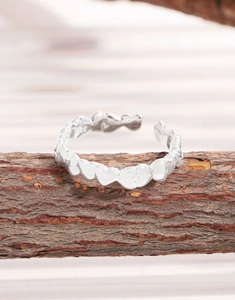Detailed close-up of S925 sterling silver stamp on the heart-shaped open ring band