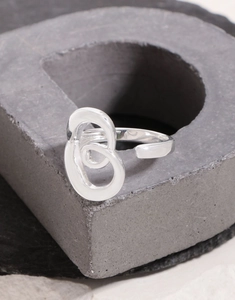 Detailed macro view of an S925 sterling silver open ring with unique abstract swirl design