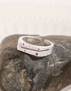 Macro shot of S925 sterling silver double-layered ring with pink zircon and hammer texture
