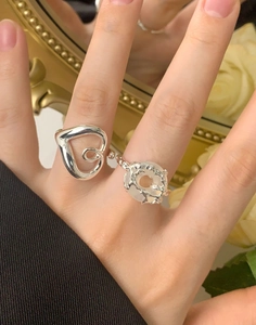 Close-up of S925 sterling silver hollow heart ring and moonstone gemstone ring set