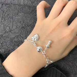 S925 Sterling silver bead bracelet with heart bow and nail charms on female wrist
