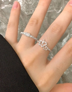Close-up of S925 sterling silver rings with twisted texture and zircon flower accents