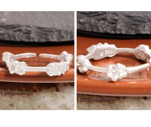Detailed close-up of S925 sterling silver hallmark on the floral heart cluster ring