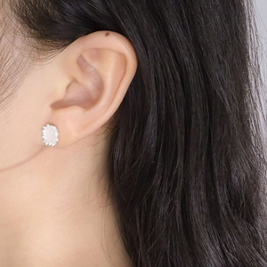 Elegant geometric pink crystal stud earrings in S925 sterling silver worn by a model