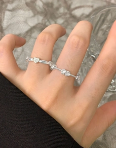 Macro detail of S925 sterling silver ring with cubic zirconia and heart-shaped element