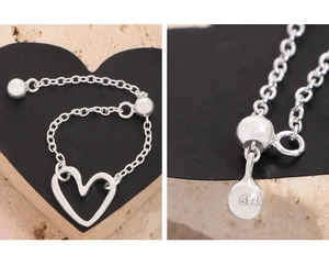 Detailed close-up of S925 sterling silver stamp and adjustable heart chain ring