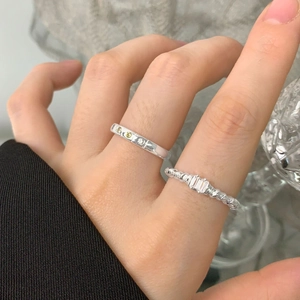 Set of 925 sterling silver rings with irregular texture and sparkling zircon stones