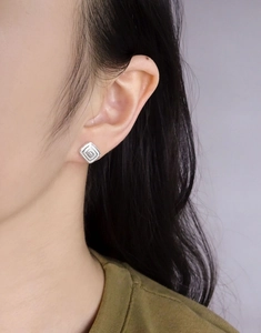 Close-up of geometric S925 silver stud earring featuring a square-cut zircon stone