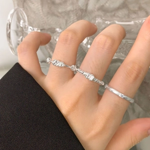 Set of three S925 sterling silver floral rings including textured bands and zircon stones