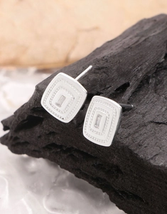 Macro shot of S925 sterling silver square earrings with baguette cut zircon inlay