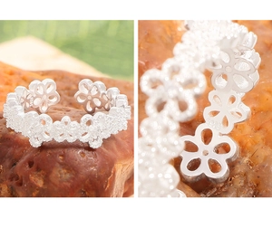 Macro detail of S925 sterling silver hollow floral ring with hallmark engraving