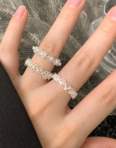 Close-up of S925 sterling silver lace flower ring set with pearls and hollow floral carvings