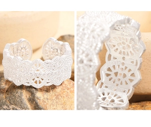 Macro shot of S925 sterling silver ring showing intricate lace texture and zircon stones