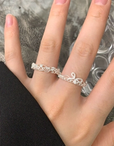 Detail of S925 sterling silver lace crown ring with bow design and zircon inlay