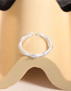 Macro detail of silver bamboo textured ring with matte finish and zircon stones