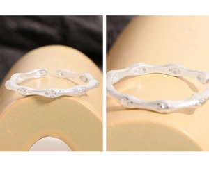 Macro detail of S925 sterling silver stamp on textured bamboo-style wave ring