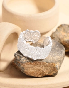 Detailed macro view of S925 sterling silver lace ring with hollow floral patterns on stone