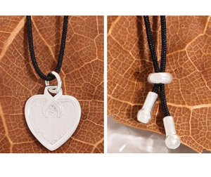 Detail of S925 sterling silver heart pendant with black cord and adjustable metal clasp