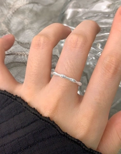 Macro detail of S925 sterling silver ring with textured branch design and tiny zircons