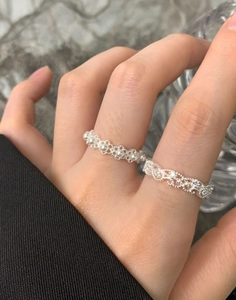 Macro detail of S925 silver lace crown rings with pearls on hand for elegant styling